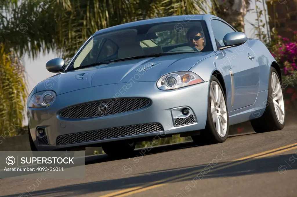 2007 Jaguar XKR driving on a suburban road, front 3/4
