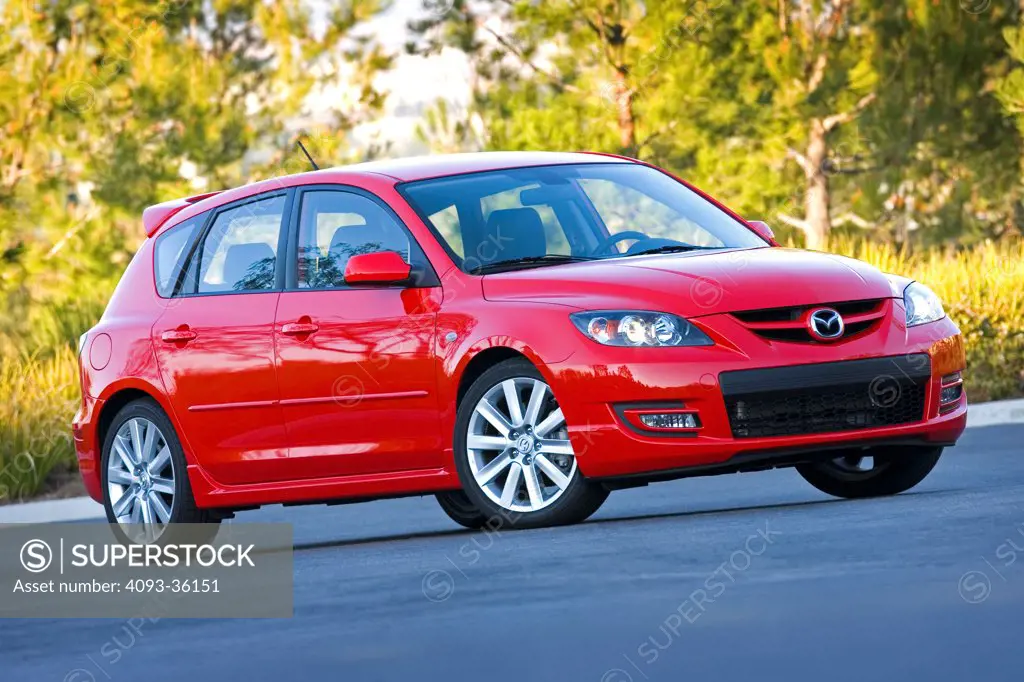 2010 Mazda Mazdaspeed 3 parked in a rural tree lined location, front 3/4