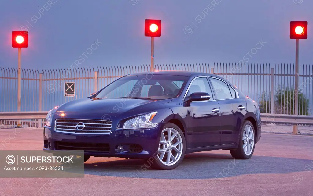 2009 Nissan Maxima 3.5 SV parked by river at dusk, front 3/4