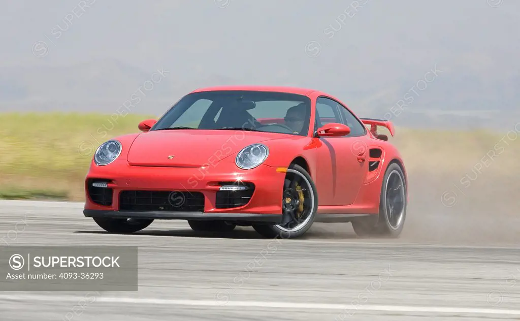 2008 Porsche 911 997 GT2 driving on a race track, front 3/4