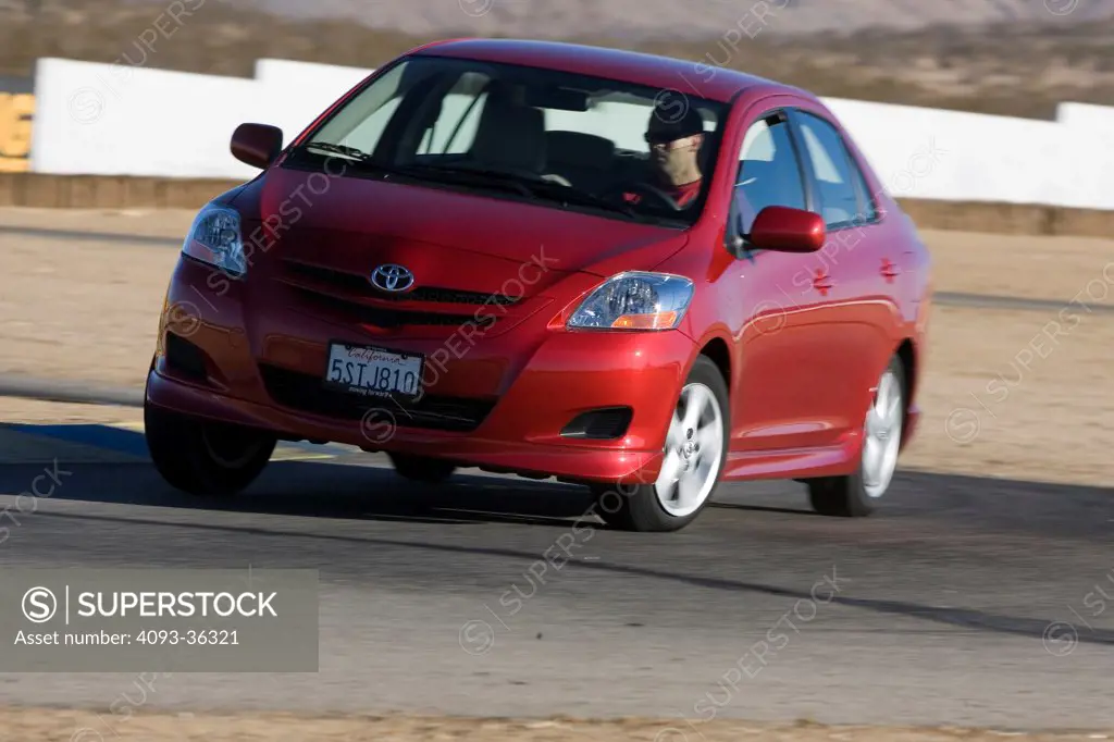 2007 Toyota Yaris S driving, cornering on a race track, front 3/4