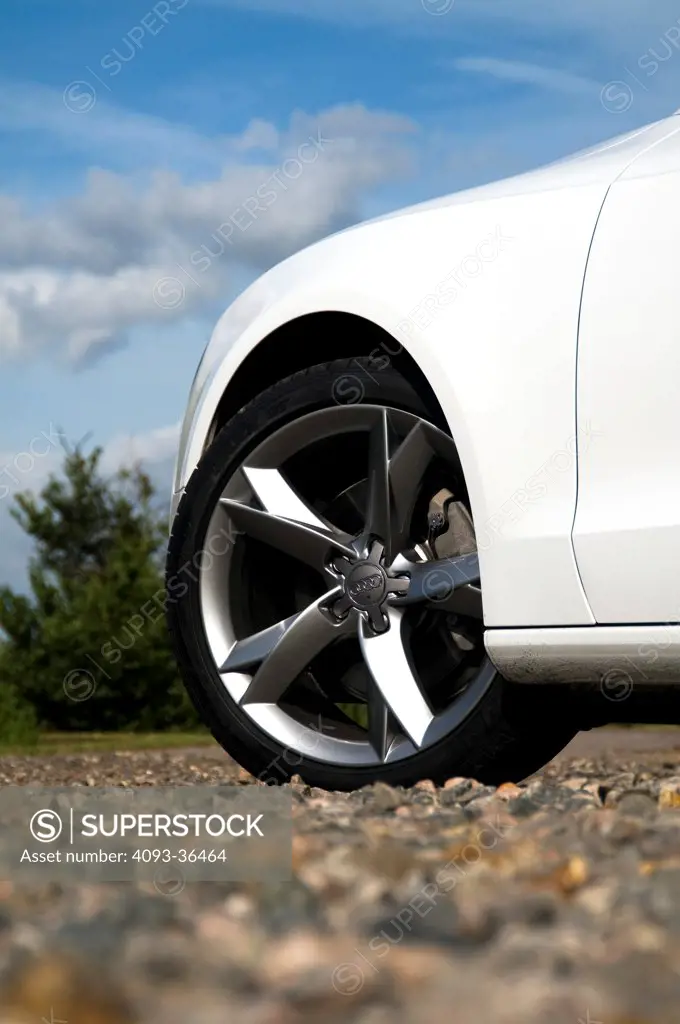 2010 Audi A5 in rural location, parked on gravel, close-up on wheel rim
