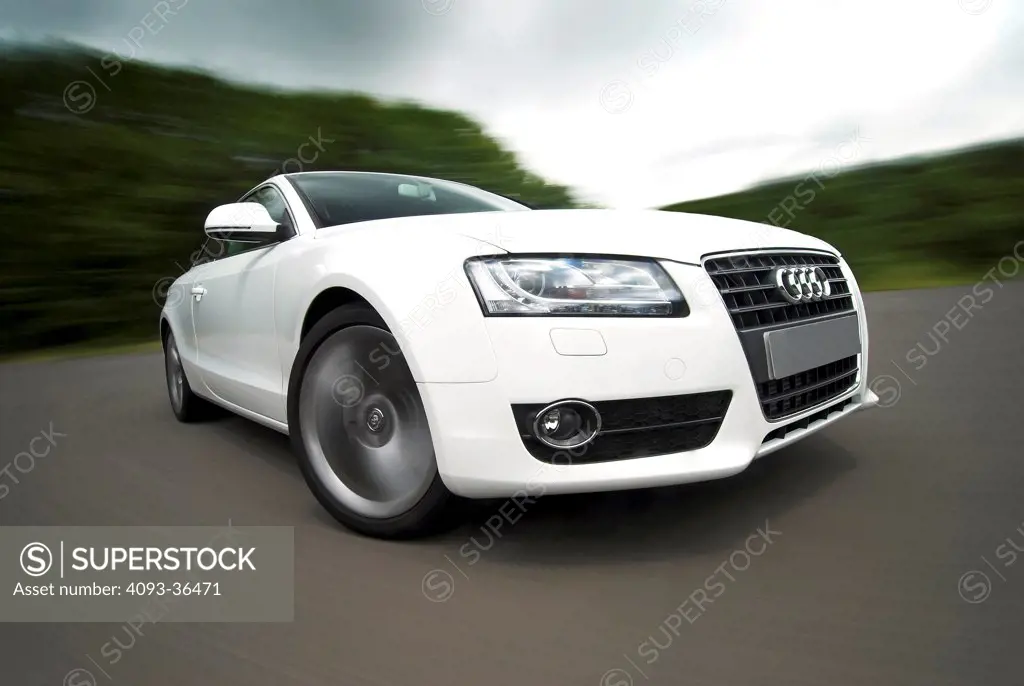 2010 Audi A5 on move on rural road, front 3/4