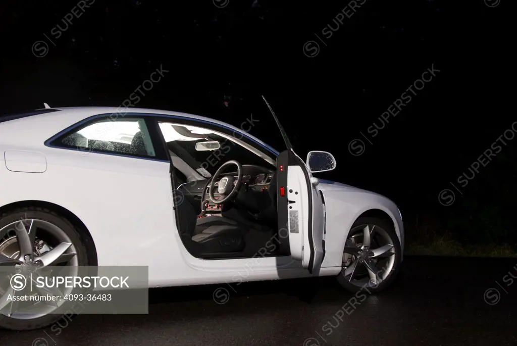 2010 Audi A5 parked in rural location with driver's door open and view of interior