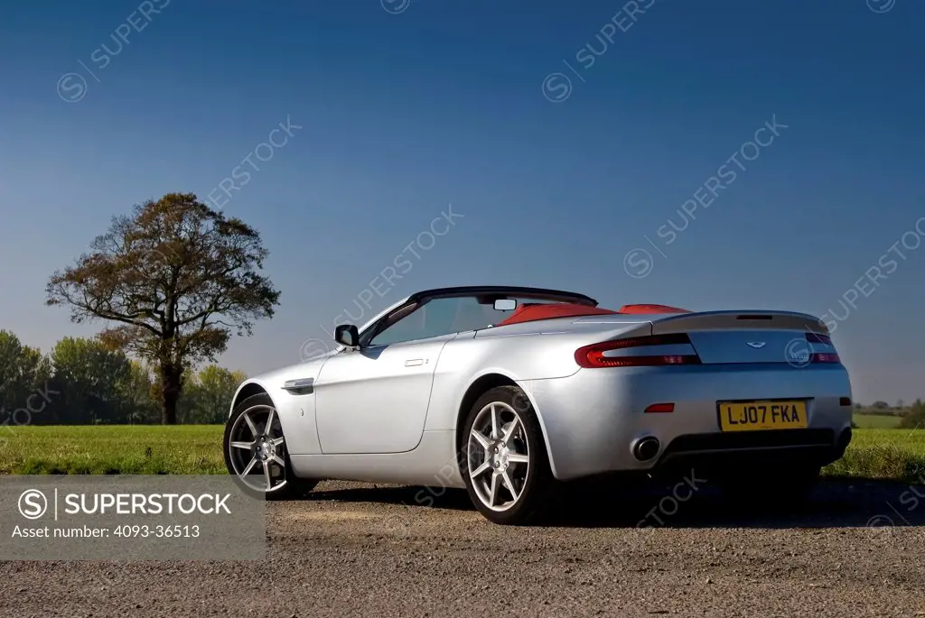 2009 Aston Martin V8 Vantage parked on rural road, rear 3/4