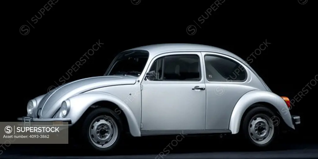 Side view of a silver VW beetle in the studio