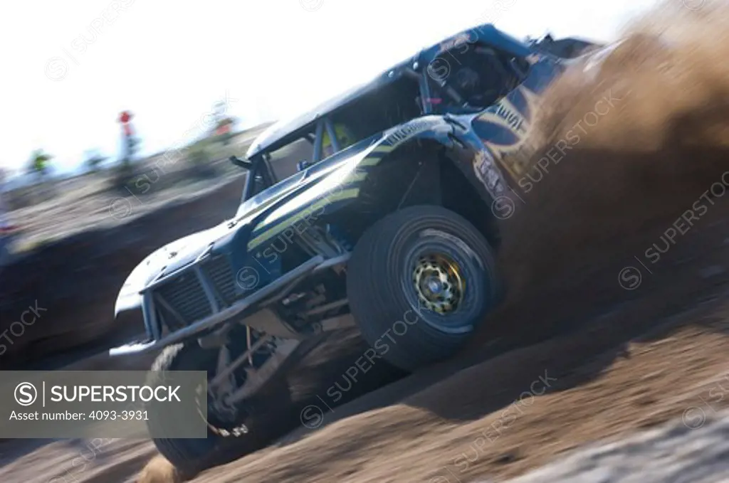Robby Gordon's Trophy Truck speeding along dirt track