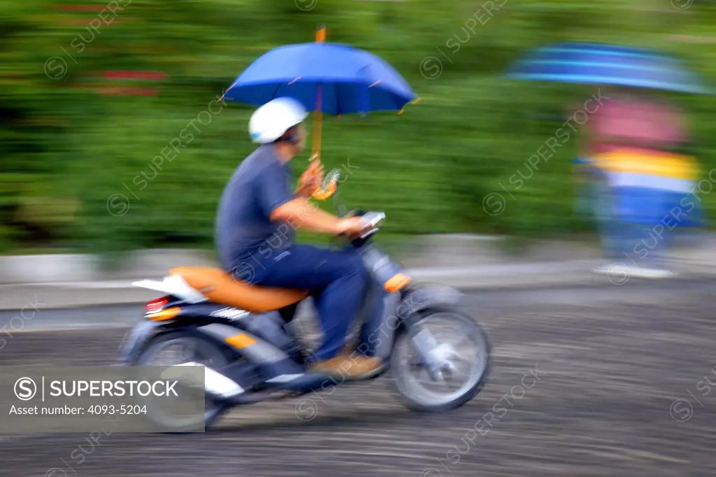 man on scooter in rain action motion