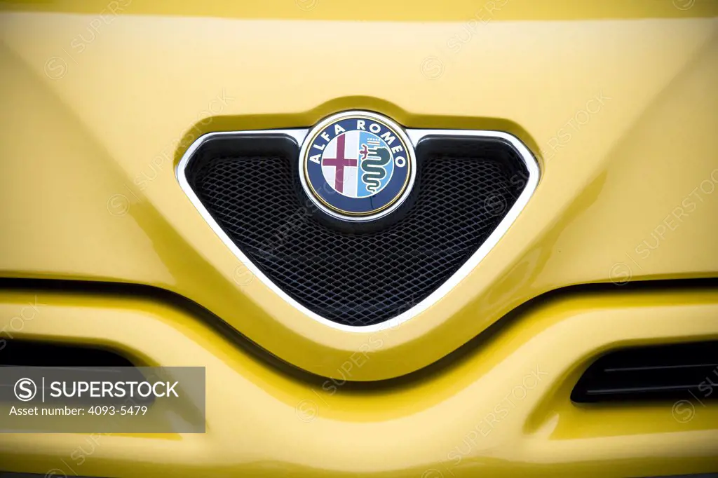 close up shot of an Alfa Romeo logo on the front grill.