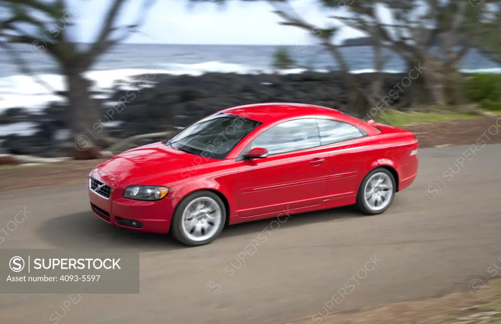 2006 Volvo C70 in Hawaii hard top convertible driving by the beach