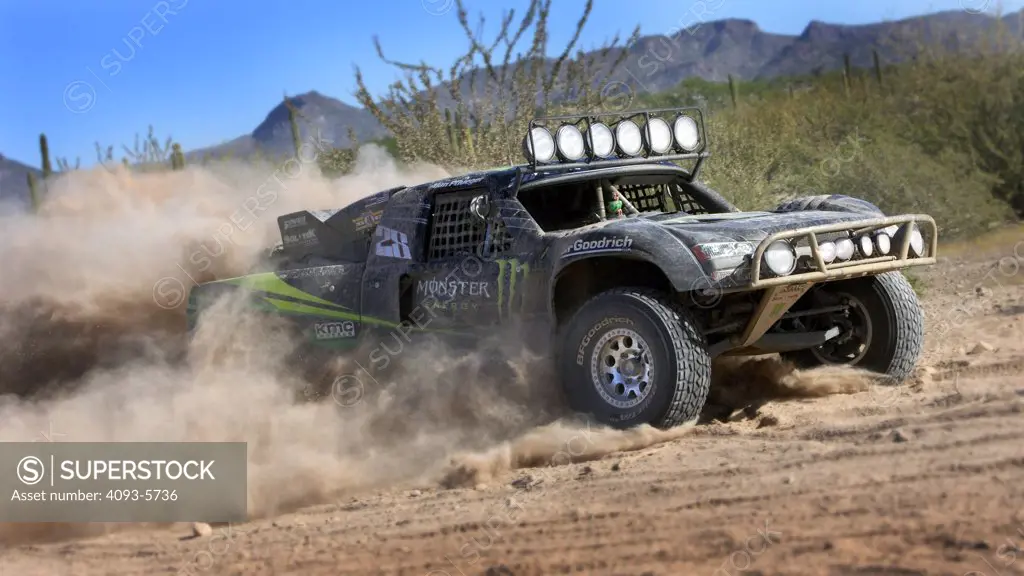 Baja Race Truck off road racer racing mud and dirt flying Offroad racing in the dirt desert