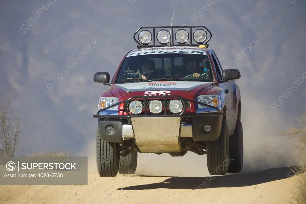 Baja Race Truck off road racer racing mud and dirt flying Offroad racing in the dirt desert