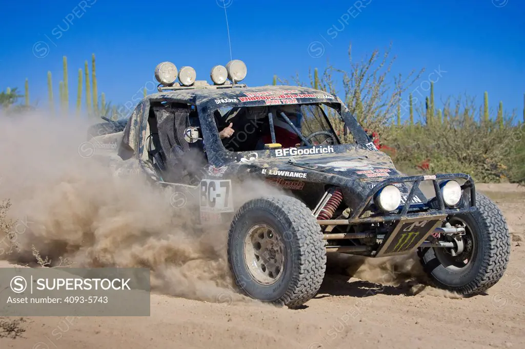 Custom Dirt racer dune buggy racing through the dirt and mud  Offroad Off road racing in the dirt desert