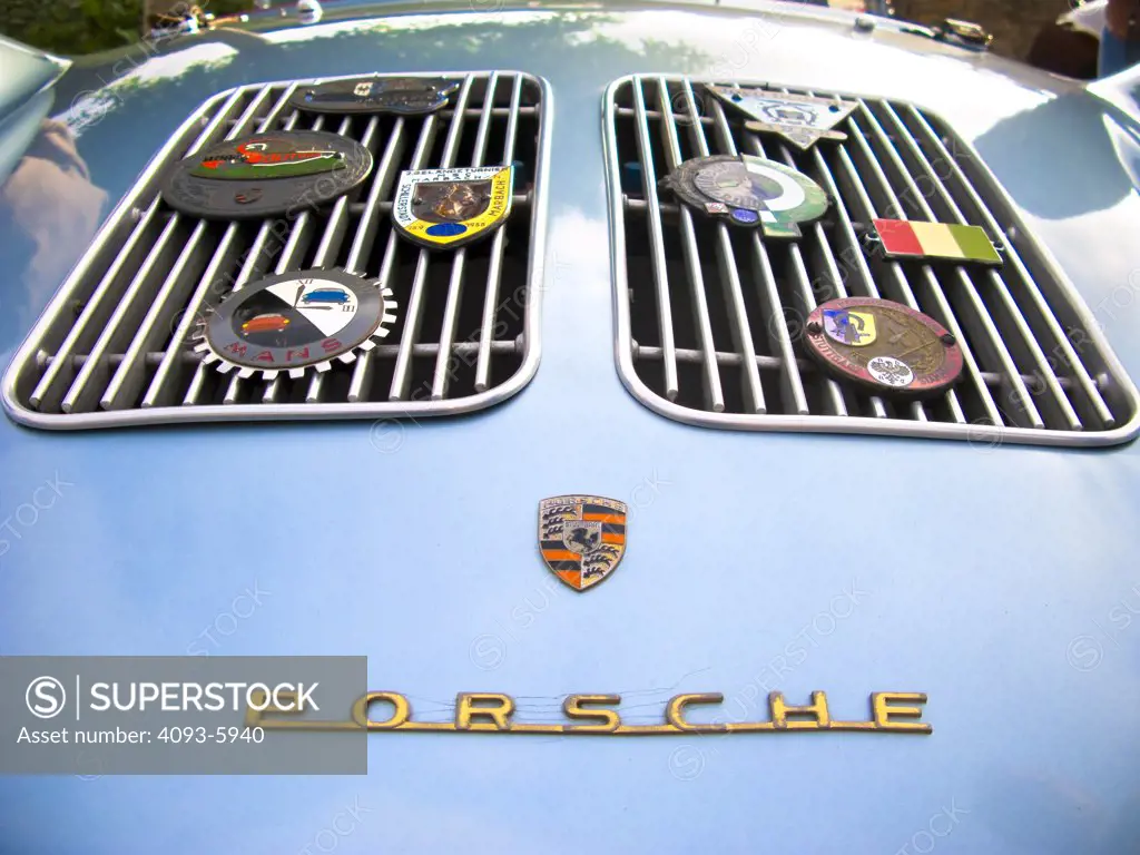 Old Porsche detail shot if the engine vents with different badges on it