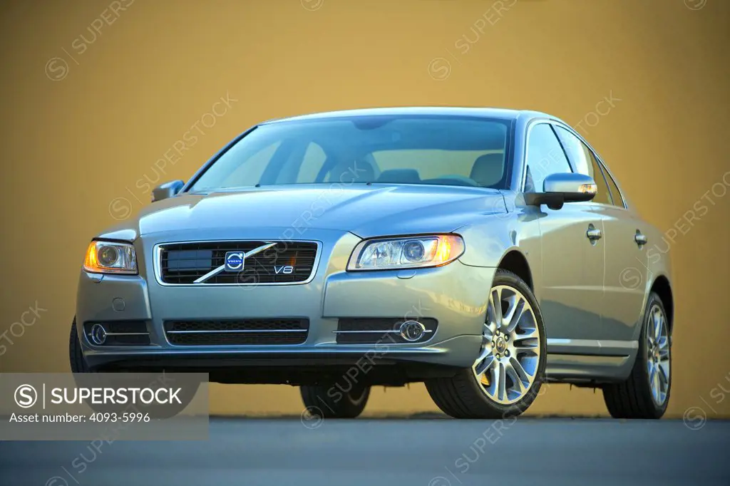 2008 Volvo S80 in front of a yellow wall