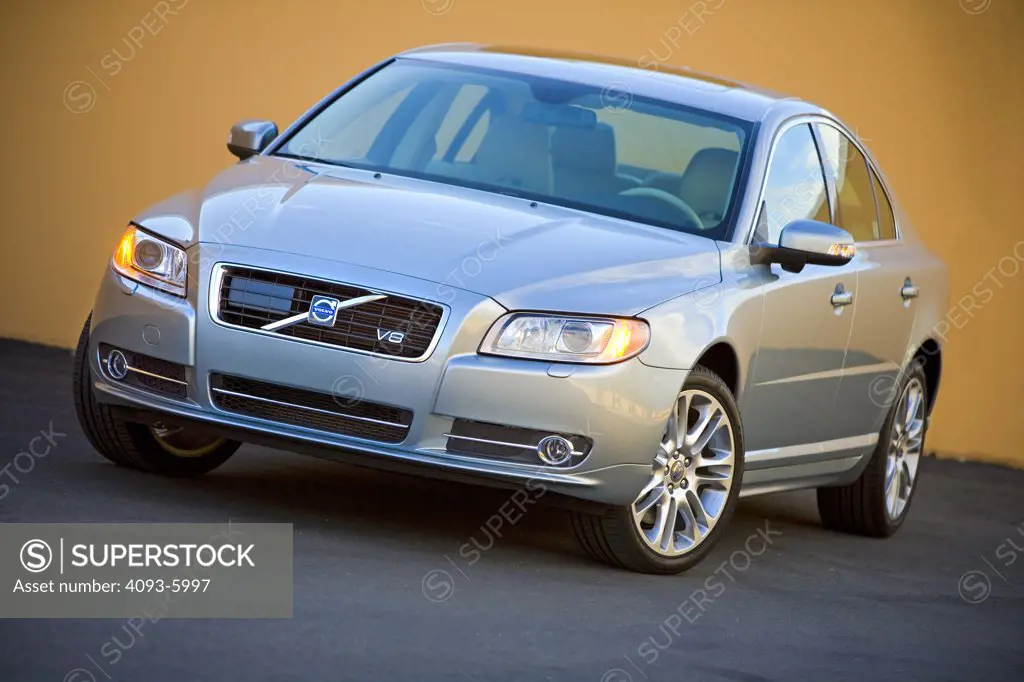 2008 Volvo S80 in front of a yellow wall