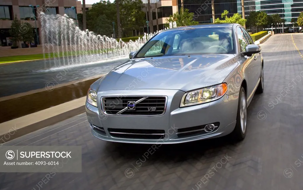 2008 Volvo S80 in motion passing corporate buildings.