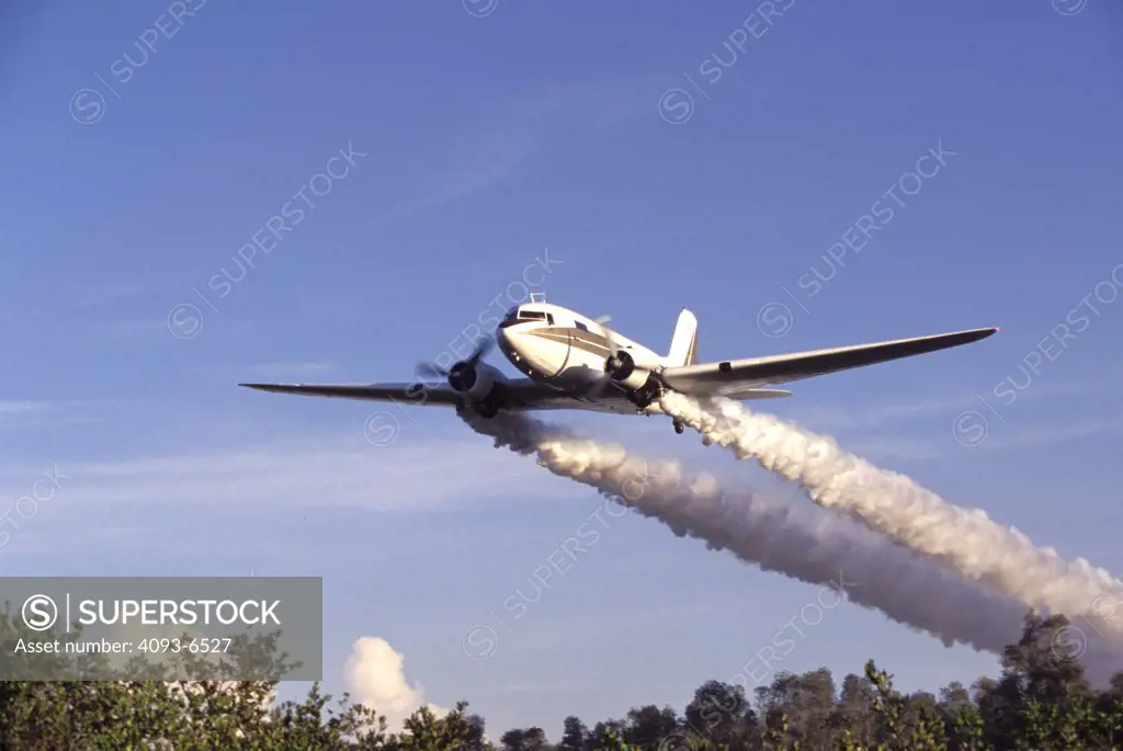 Fixed Wing Aviat Airplanes DC-3 mosquito sprayer crop duster white front 3/4 underneath trees sky