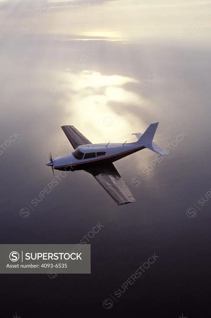 single airplane flying over the ocean