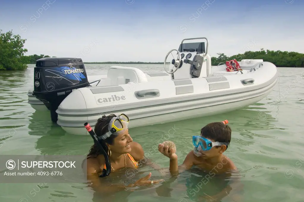 Caribe inflatable raft boat mother son diving snorkeling