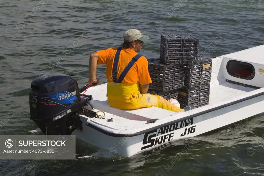 fisherman taking stone crab traps out  Lil Torch Key, Florida MR:Y Winston Luzier Tohatsu 25 4 stroke engine Carolina skiff J 16
