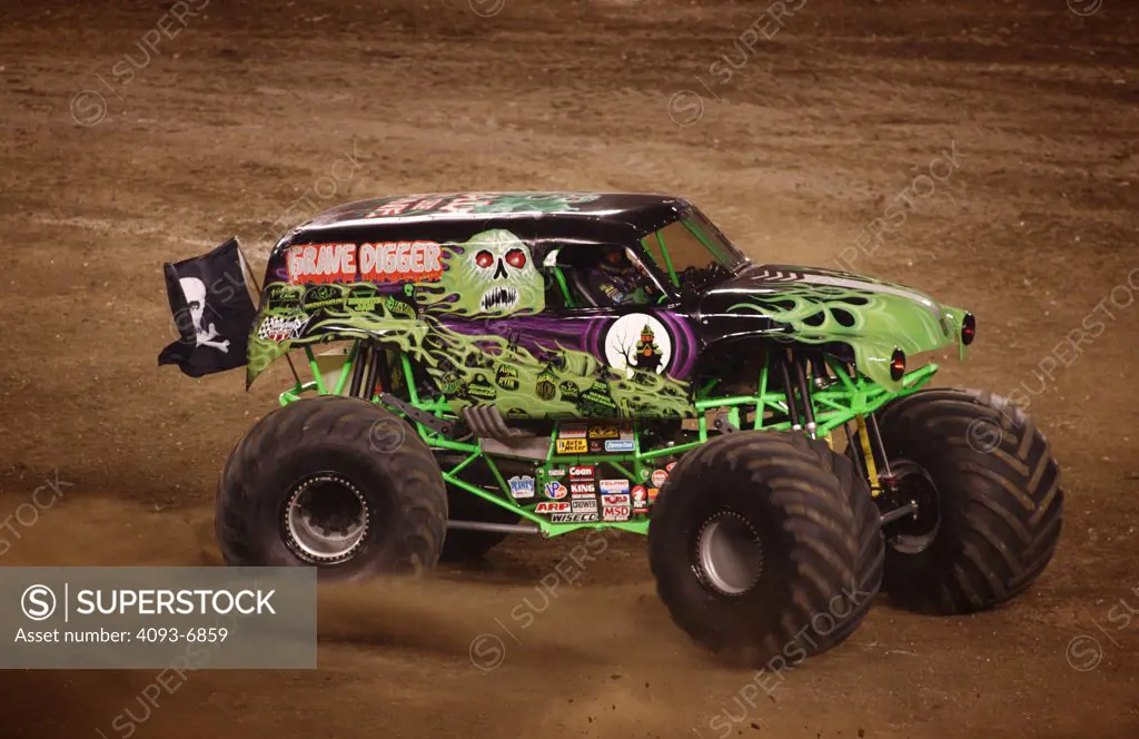 Grave digger Monster Truck at a Monster Truck Rally in Raymond James Stadium, Tampa, FL. A monster truck is an automobile, typically a pickup truck, which has been modified or purposely built with extremely large wheels and suspension. Typically, a monster truck show involves the truck crushing smaller vehicles beneath its huge tires. These trucks can run up and over most man-made barriers, so they are equipped with remote shut-off switches, called the Remote Ignition Interuptor (RII), to help p