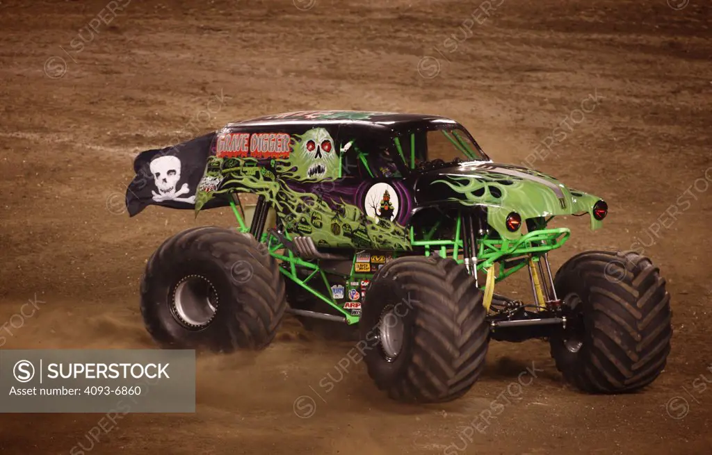 Grave digger Monster Truck at a Monster Truck Rally in Raymond James Stadium, Tampa, FL. A monster truck is an automobile, typically a pickup truck, which has been modified or purposely built with extremely large wheels and suspension. Typically, a monster truck show involves the truck crushing smaller vehicles beneath its huge tires. These trucks can run up and over most man-made barriers, so they are equipped with remote shut-off switches, called the Remote Ignition Interuptor (RII), to help p
