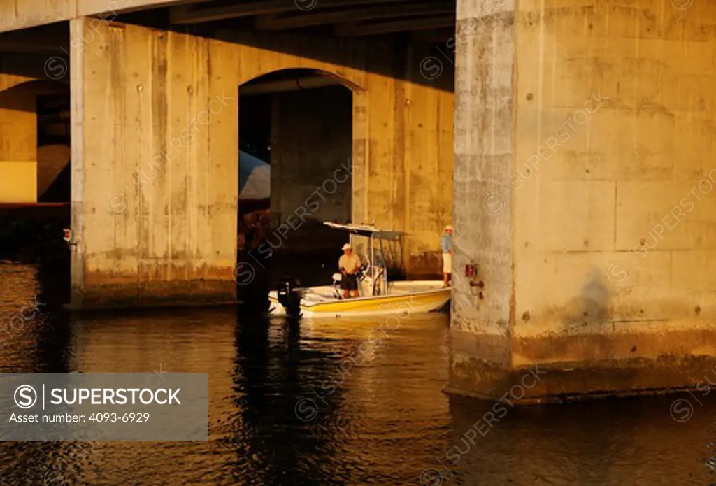 Friends / Guys fishing from a Trophy 1901 Bay Pro boat beneath a bridge in San Diego Harbor, CA.