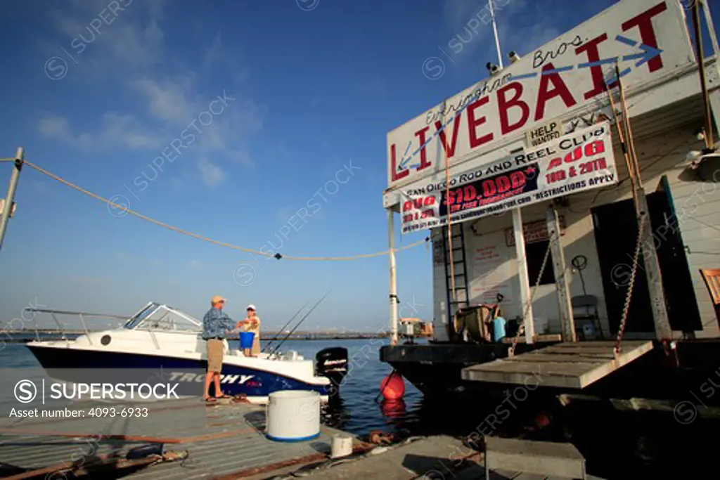 Couple getting / buying bait before heading out to go fishing in their Trophy 1902 Walkaround boat. San Diego Harbor, CA.