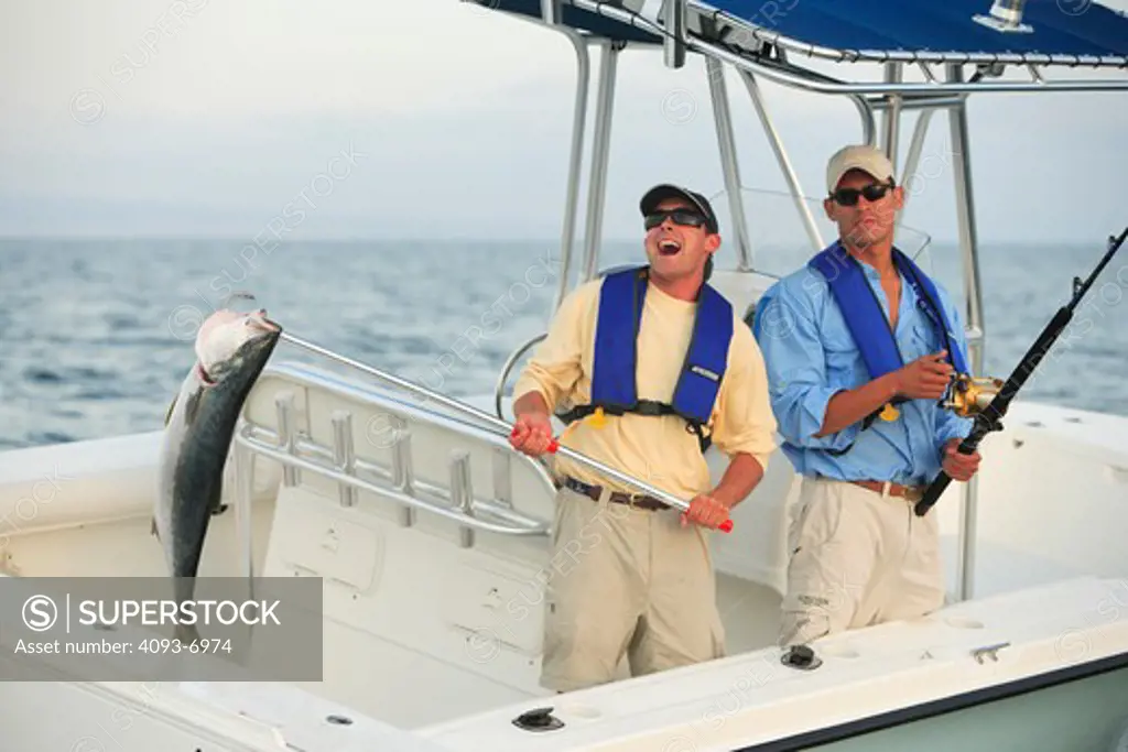 Friends / guys catching a tuna in their Trophy 2103 walkaround boat. Pacific Ocean near San Diego, CA.