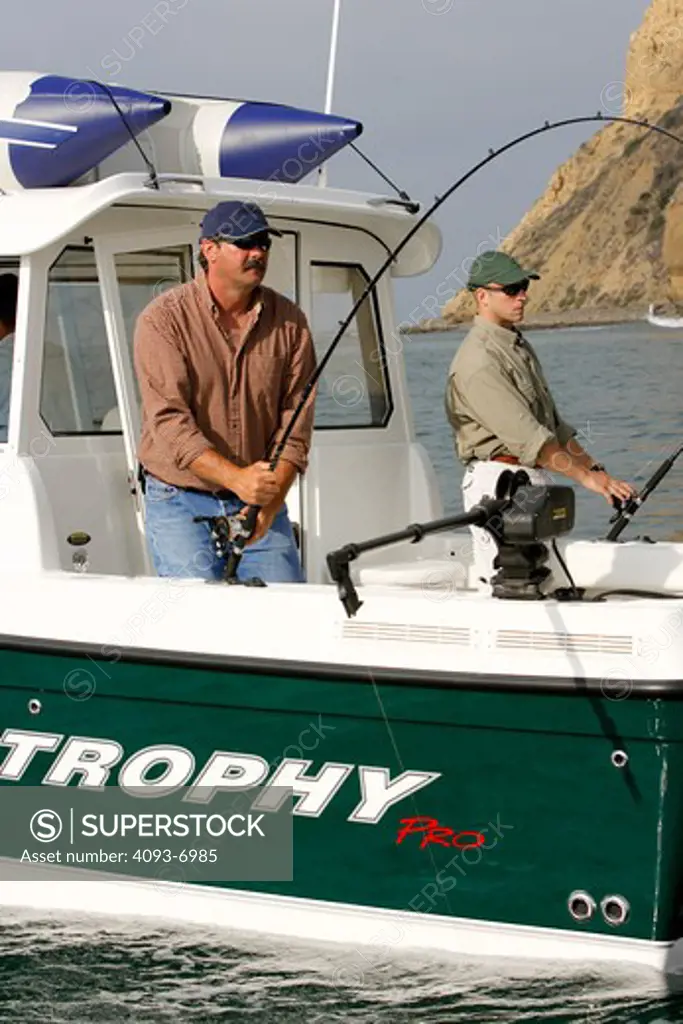 Guys / friends fishing in their Trophy 2359 Walkaround boat near the cliffs of San Diego, CA. Pacific Ocean.