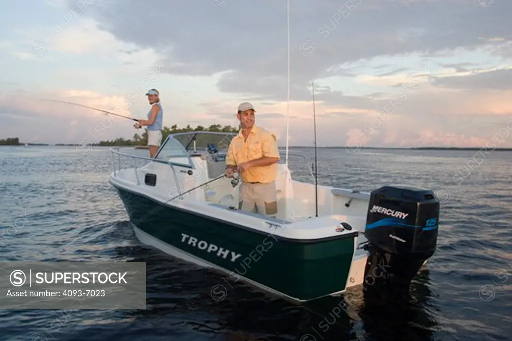 Couple fishing at sunrise in San Carlos Bay, Fort Myers, Florida.