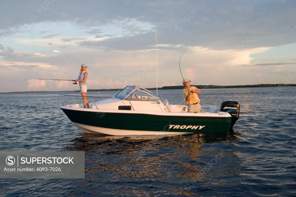 Couple fishing at sunrise in San Carlos Bay, Fort Myers, Florida.