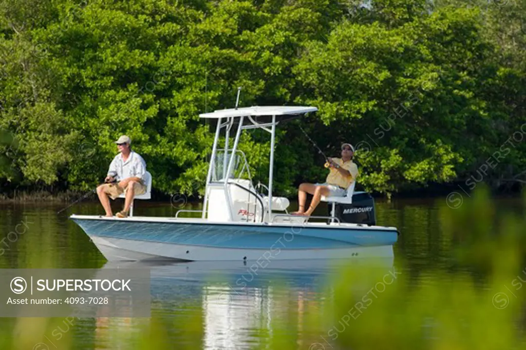 Guys / friends fishing along mangroves in San Carlos Bay, Fort Myers, Florida in a Trophy 1901 Bay Pro boat.