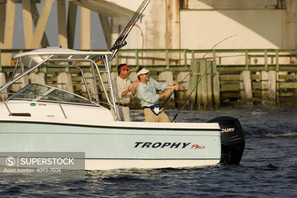 Guys / friends fishing near a bridge in San Carlos Bay, Fort Myers, Florida in a Trophy 2002 Walkaround boat.