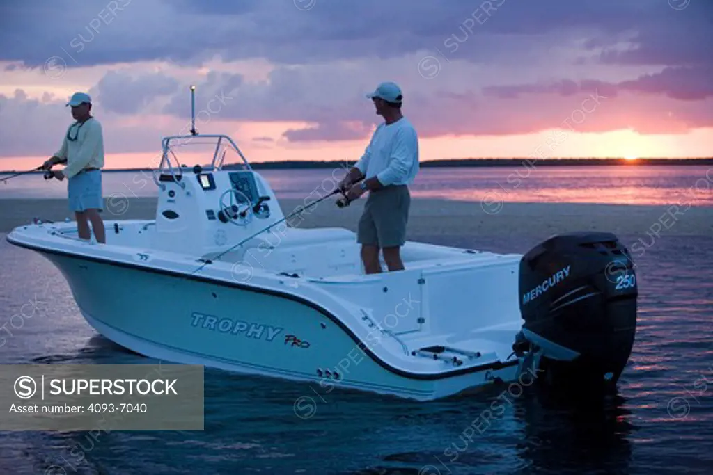 Friends / guys bayfishing at sunset in San Carlos Bay,Ft. Myers, Florida in a Trophy 2103 Center Console.