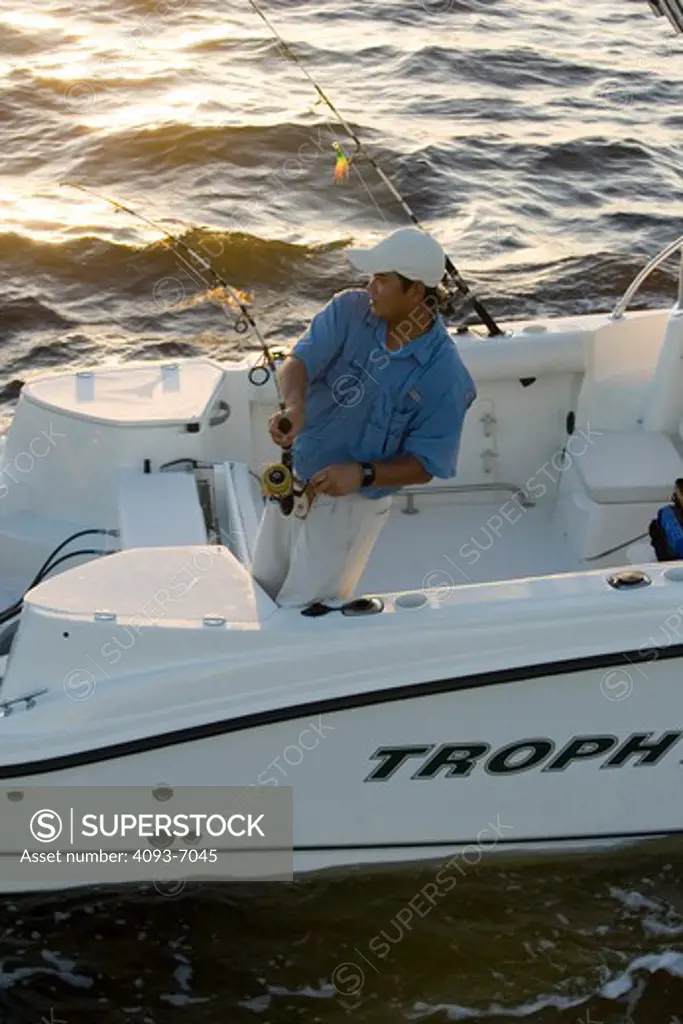 Guys / friends fishing in San Carlos Bay at dawn in a Trophy 2302 Walkaround boat. Fort Myers, FL