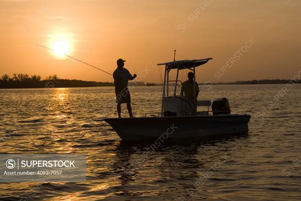 Guys / friends fishing at sunset in a Trophy 1901 Bay Pro boat
