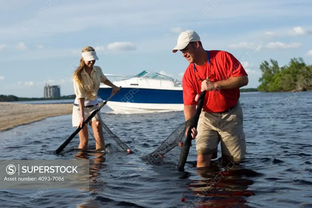 Couple seine netting along shore near Fort Myers, Florida. Trophy 2052 Walkaround boat.