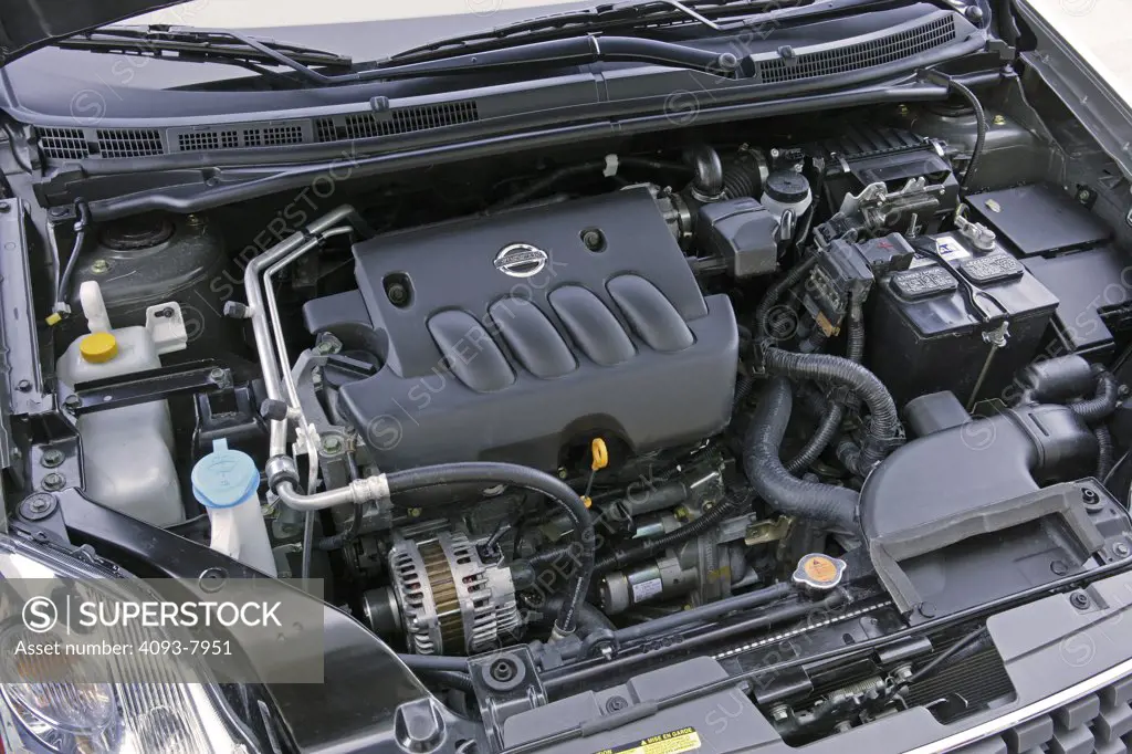 Engine view of a 2007 green Nissan Sentra sedan. Under the hood poped open