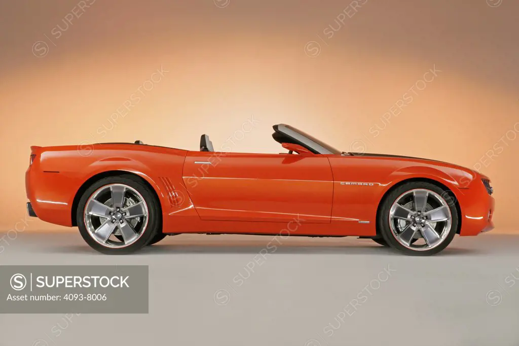 Profile view of a Chevy Camaro Convertible concept car. parked in a studio with backdrop