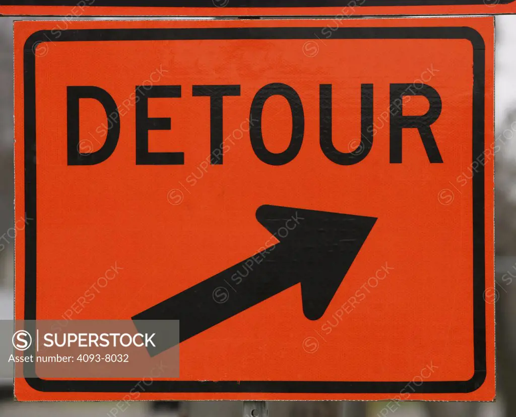 Detour sign orange instruction sign pointing a direction to the side