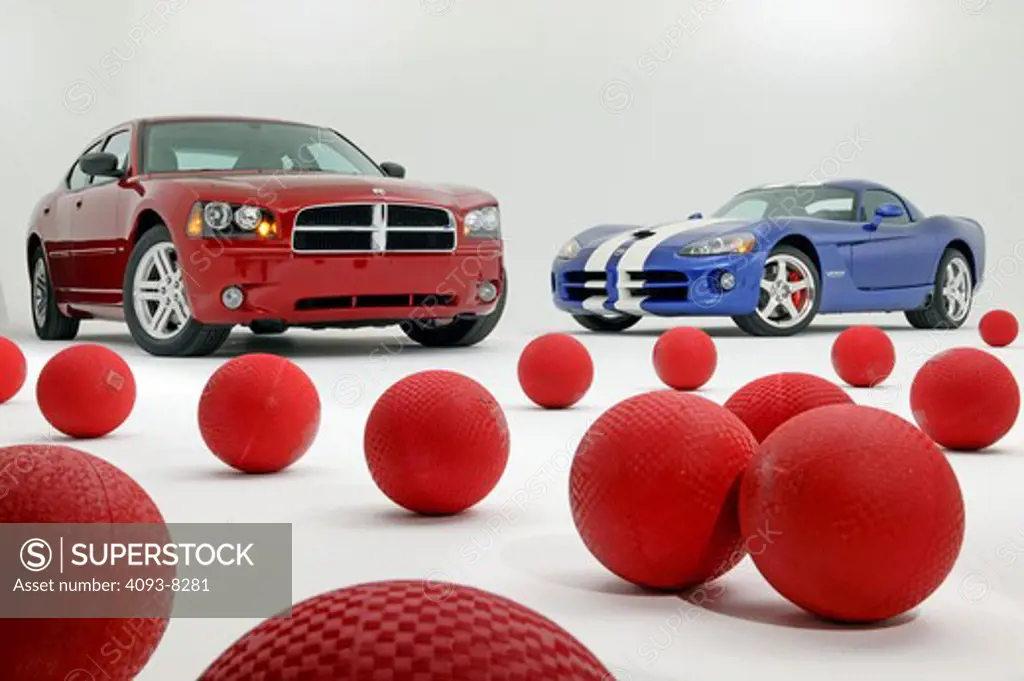 2008 Dodge Charger RT in a studio with a 2008 Dodge Viper and a bunch of red rubber balls