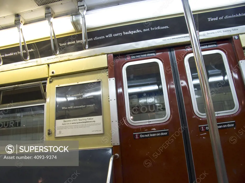 interior subway New York City doors pole handles advertisement rail city