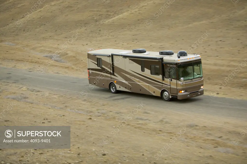 2005 brown Fleetwood Providence RV. Driving on rural California road.