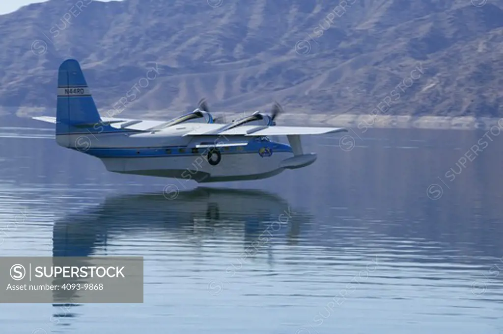 Grumman HU-16 Albatross, twin radial engine amphibious flying boat flying around and landing on Lake Mead, Nevada. Originally designated SA-16. The Albatross was designed to be able to land at sea in open ocean situations in order to effect the rescue of downed pilots. Its deep-V cross-section and substantial length helped make it possible for it to land in wavy conditions.  Since it weighs over 12,500 pounds, pilots must have a type rating in order to act as pilot or co-pilot on board the Alb