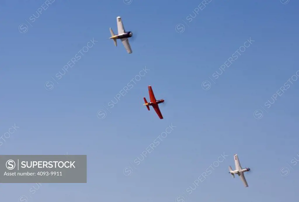 Racing airplanes at the 2008 Reno Air Races. Top to bottom are; 77 Rare Bear ( Grumman F8F-2 Bearcat ), 4 Dago Red ( North American P-51D Mustang ) and 7 Strega ( North American P-51D Mustang ). This is the Unlimited Gold class.