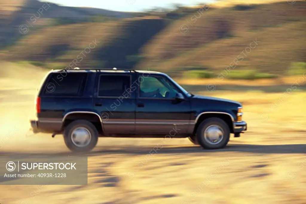 1997 Chevy Tahoe blue profile dust off-road blur man 1990s