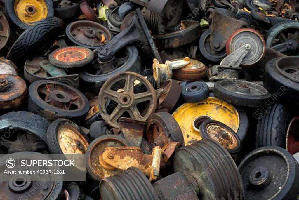 old wheels junkyard scrapyard pile rust car parts