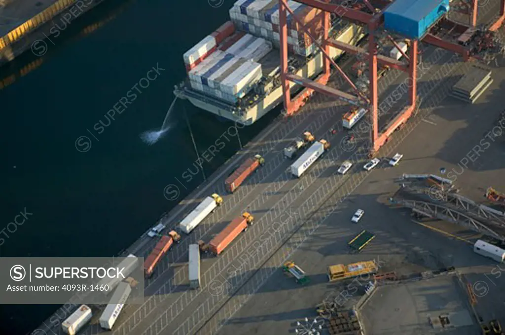 overhead Commercial container carrier cargo freighter port harbor dock Long Beach California aerial